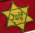 Yellow badge made mandatory by the Nazis in France. "Juif" means Jew in French